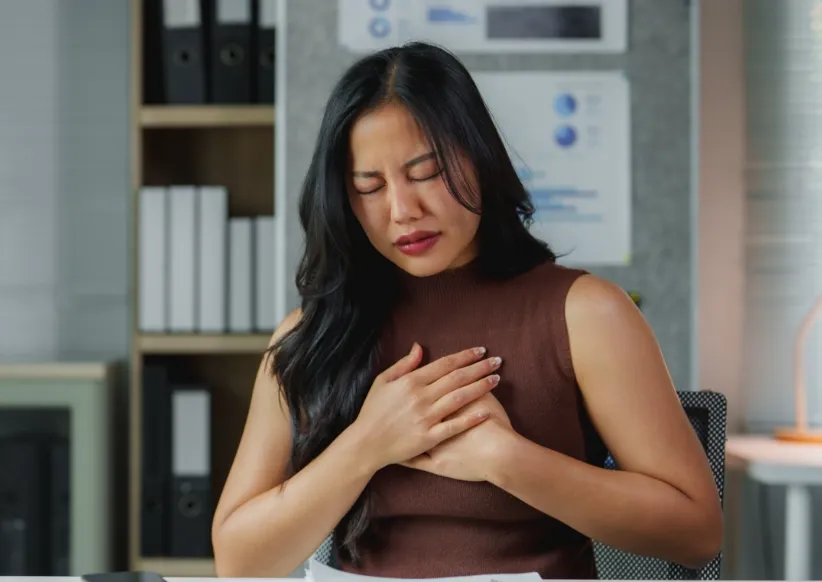 asian businesswoman suffering chest pain while wor utc