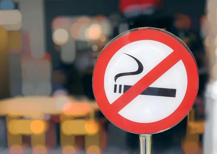 close up circular red and white no smoking sign at utc