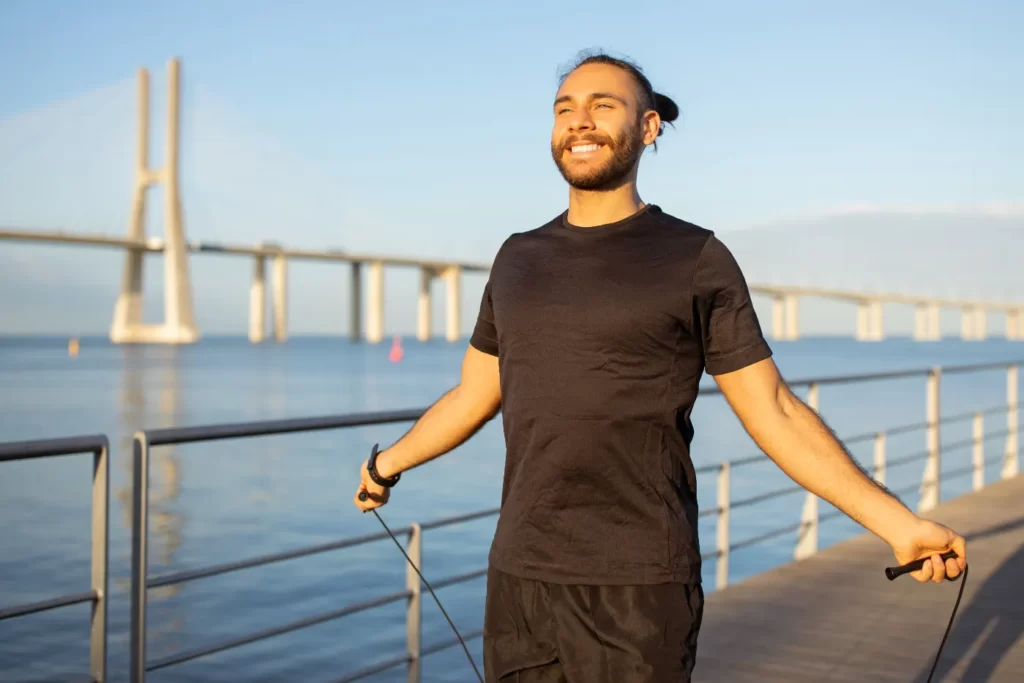 man-exercising-outdoors-with-jump-rope-near-bridge-2026-03-24-02-03-00-utc