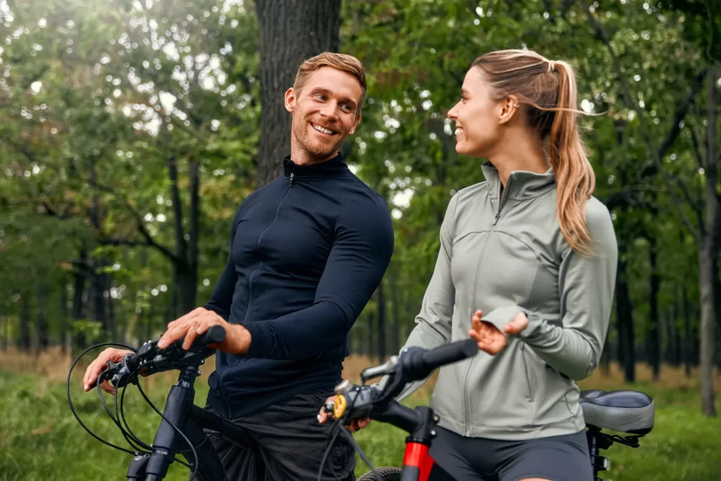smiling-man-and-woman-with-bicycles-in-nature-2026-03-24-15-03-31-utc