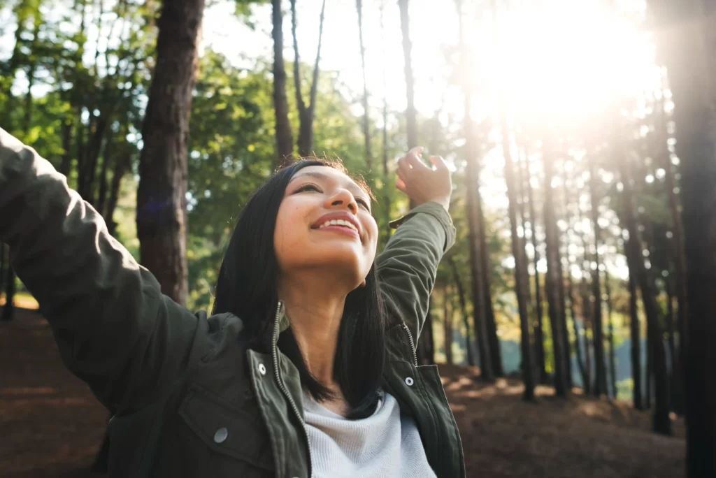 smiling-woman-enjoying-nature-and-forest-sunshine-2026-01-07-23-43-38-utc