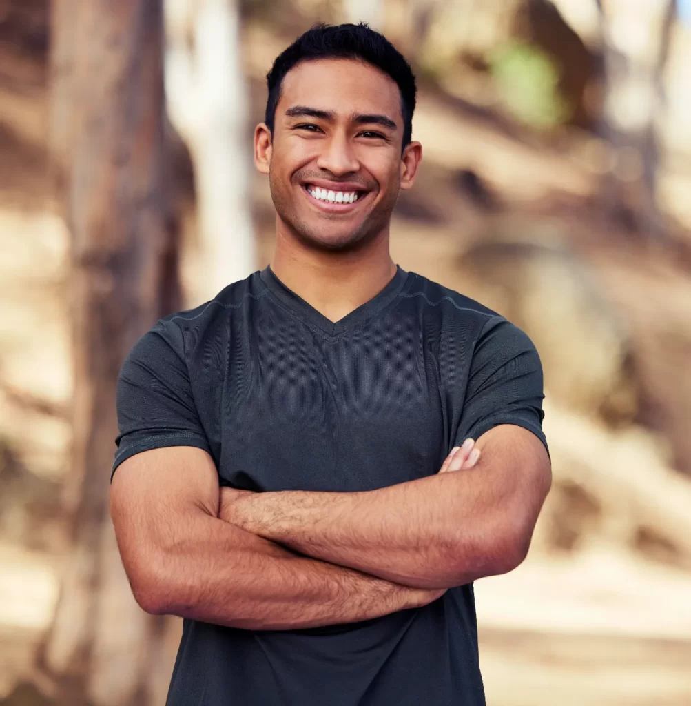 smiling-young-man-with-crossed-arms-outdoors-2026-01-09-09-14-27-utc