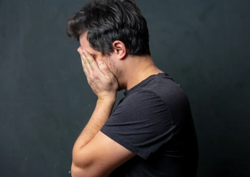 tired brunet man in black t shirt on dark backgrou utc ()