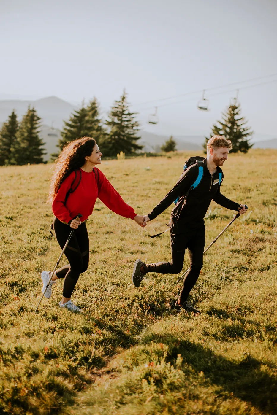 young-couple-walking-with-backpack-over-green-hill-2026-03-23-23-23-06-utc